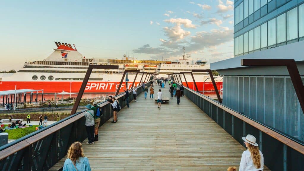 Passengers walking beside a Spirit of Tasmania ferry at the Devonport terminal