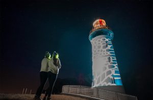 Apart of Permission to Trespass event in Table Cape Lighthouse illuminated against the dark night sky near Wynyard, Tasmania.
