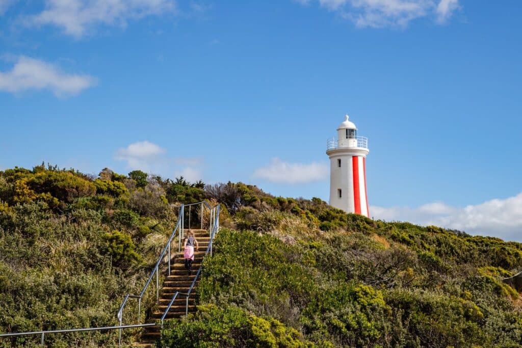 Walker approaching the red-and-white Mersey Bluff Lighthouse in Devonport, Tasmania.