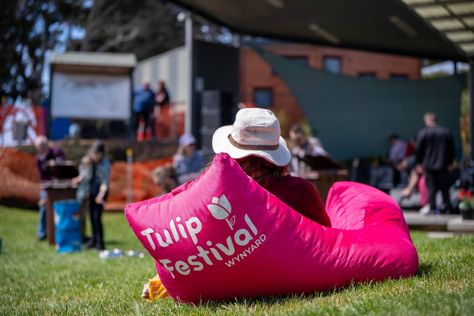 Visitor relaxing on a pink beanbag at the Wynyard Tulip Festival