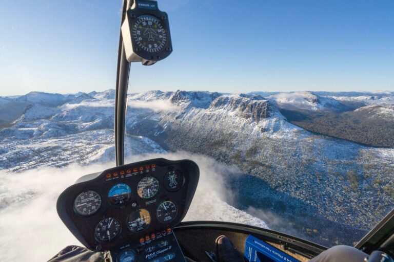 View from a helicopter flying over snow-covered mountains in North West Tasmania near Cradle Mountain
