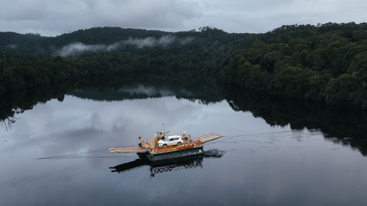 Vehicle crossing the Pieman River on the Fatman Barge near Corinna, Tasmania