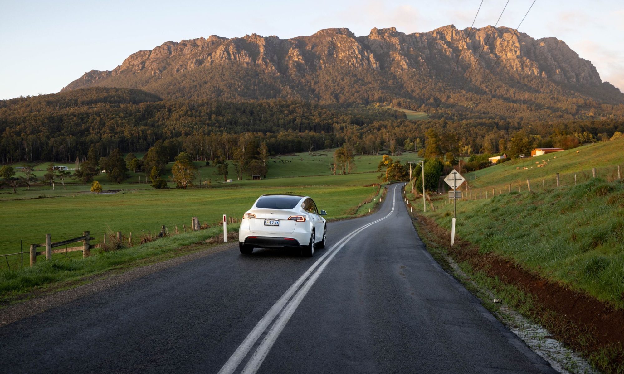 Car travelling along a country road towards Mount Roland near Sheffield, Tasmania.