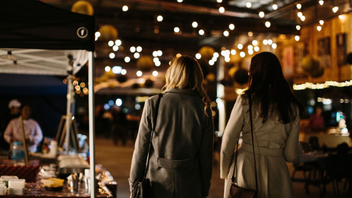 two people walking. through a market in Devonport
