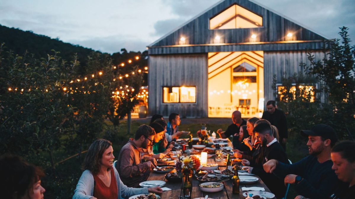 Guests sharing an outdoor dinner at Mount Gnomon Farm near Penguin, Tasmania
