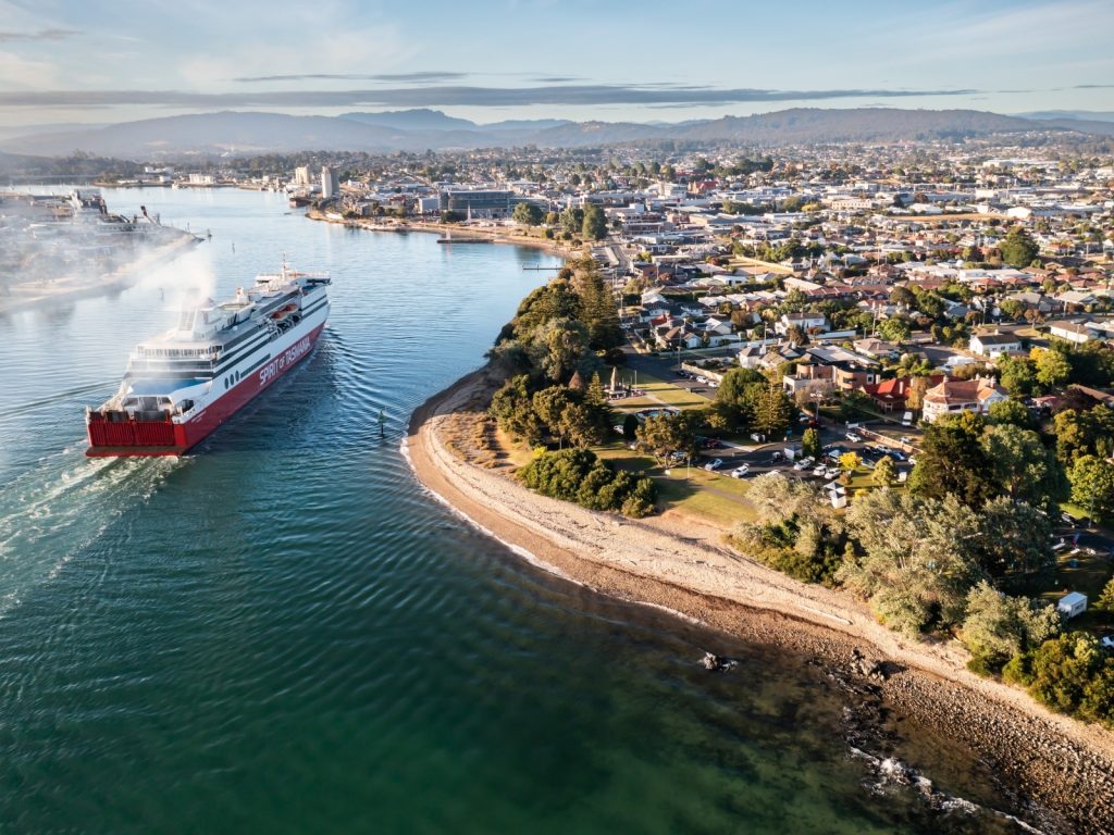 Aerial view of a Spirit of Tasmania ship travelling along the Mersey River beside Devonport’s waterfront.